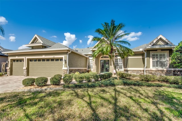 view of front of house with a garage and a front yard