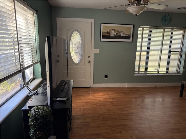 entryway featuring hardwood / wood-style flooring, ceiling fan, and plenty of natural light