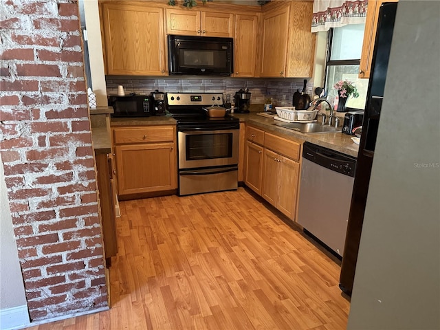 kitchen with tasteful backsplash, sink, light hardwood / wood-style flooring, and stainless steel appliances