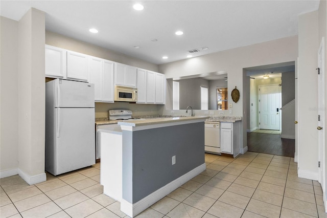 kitchen featuring white cabinetry, light tile patterned floors, white appliances, and kitchen peninsula