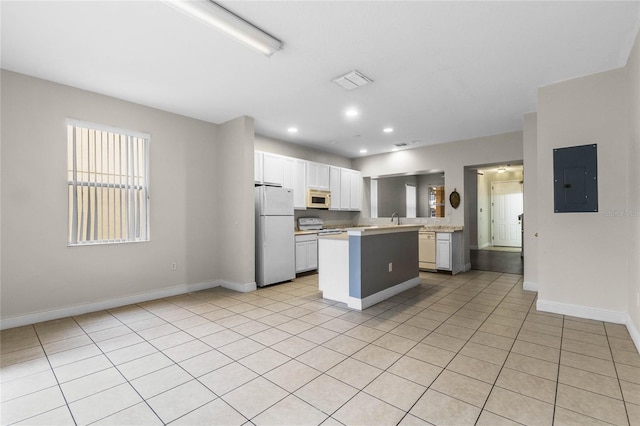 kitchen with white cabinetry, a center island, light tile patterned floors, electric panel, and white appliances