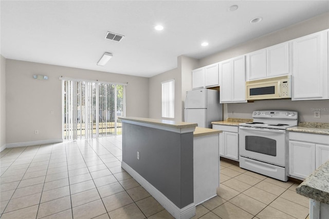 kitchen with white cabinetry, a center island, light tile patterned flooring, and white appliances