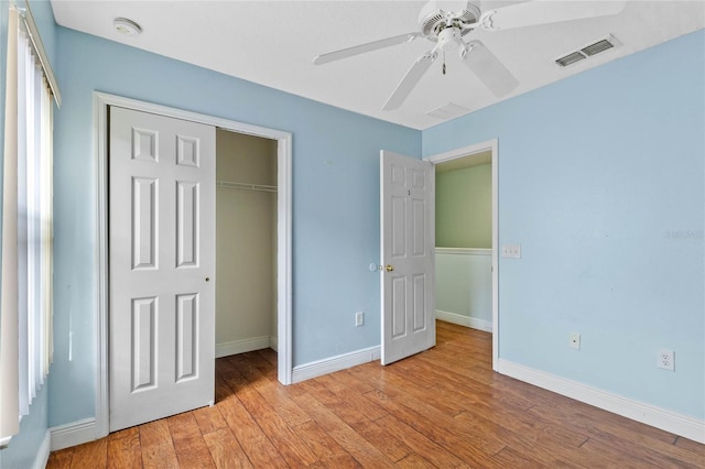 unfurnished bedroom featuring light hardwood / wood-style flooring, a closet, and ceiling fan