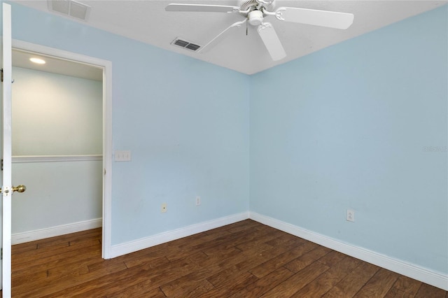 unfurnished room featuring ceiling fan and dark hardwood / wood-style flooring