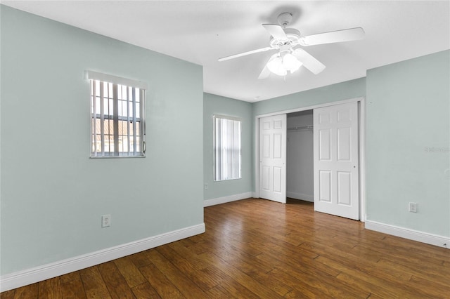 unfurnished bedroom featuring hardwood / wood-style flooring, ceiling fan, and a closet