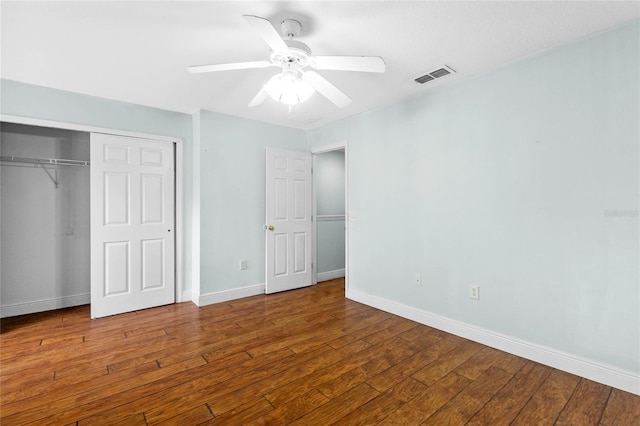 unfurnished bedroom featuring wood-type flooring, ceiling fan, and a closet