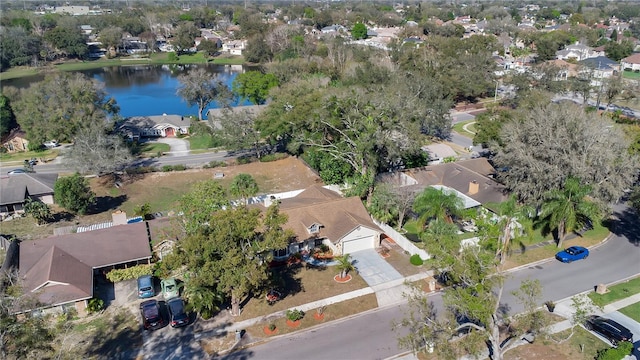 birds eye view of property with a water view and a residential view