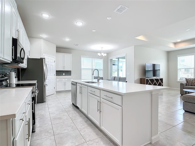 kitchen featuring sink, white cabinetry, a center island with sink, electric range oven, and stainless steel dishwasher