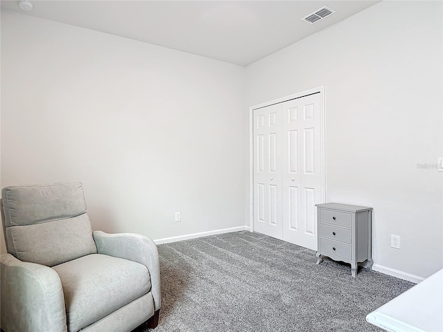 living area featuring dark colored carpet