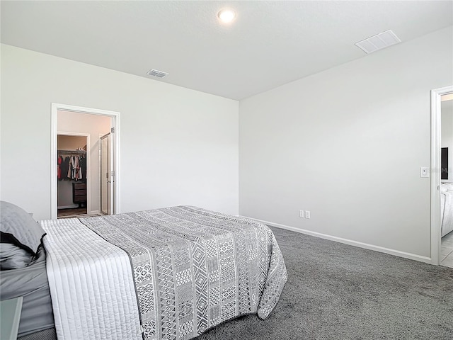 carpeted bedroom with a spacious closet