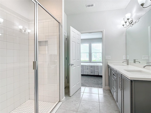 bathroom featuring vanity, a shower with shower door, tile patterned floors, and a textured ceiling