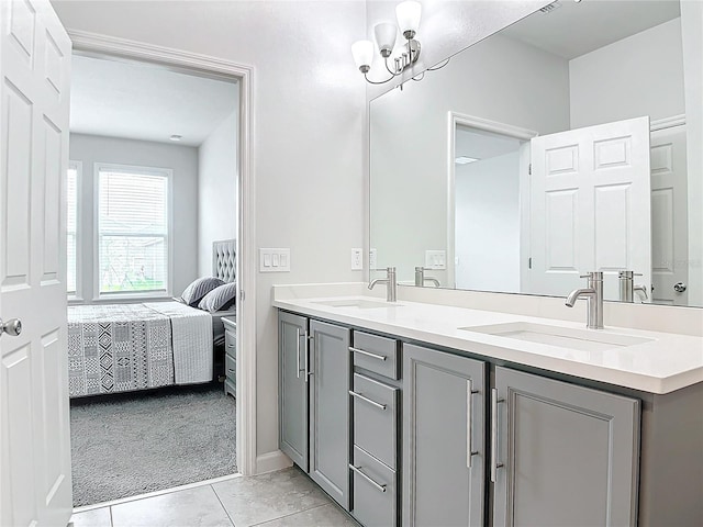 bathroom with tile patterned floors, vanity, and a notable chandelier