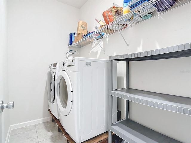 laundry area featuring separate washer and dryer and light tile patterned floors