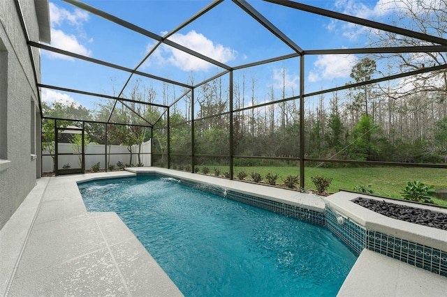 view of pool with a yard, glass enclosure, and a patio area