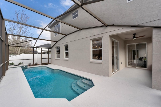 view of pool with a lanai and ceiling fan