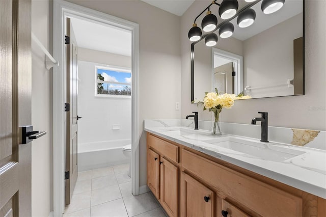 full bathroom with tile patterned floors, toilet, vanity, and shower / washtub combination