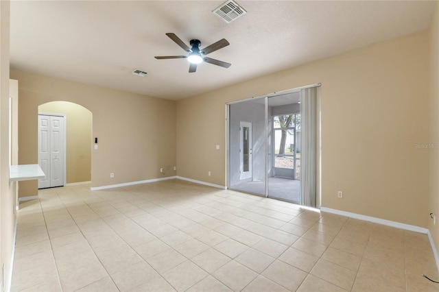 spare room featuring light tile patterned floors and ceiling fan