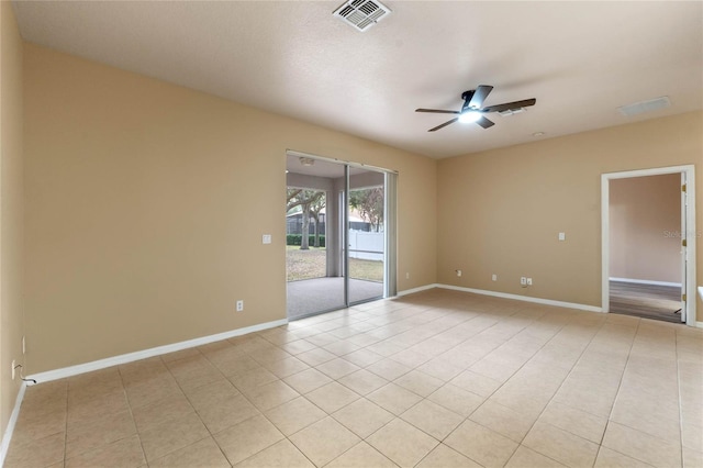 spare room featuring ceiling fan and light tile patterned floors