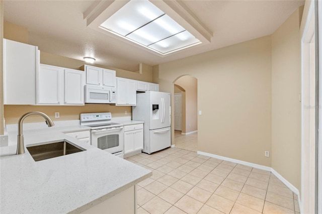 kitchen with white cabinetry, white appliances, sink, and light tile patterned floors