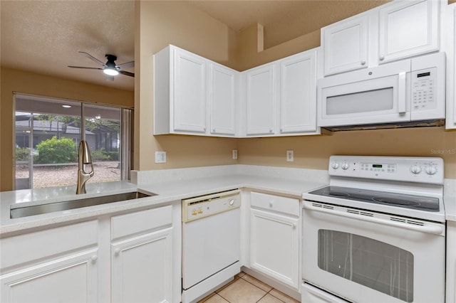 kitchen featuring sink, white appliances, ceiling fan, white cabinets, and light tile patterned flooring