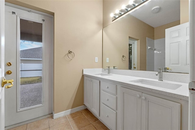 bathroom with vanity, tile patterned floors, and a shower