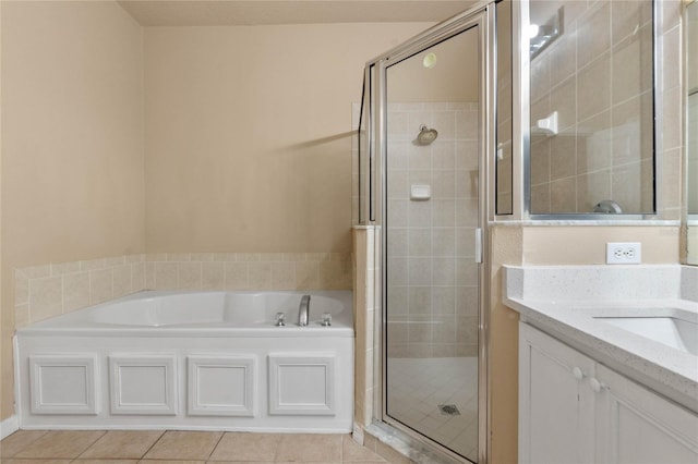 bathroom featuring plus walk in shower, tile patterned floors, and vanity