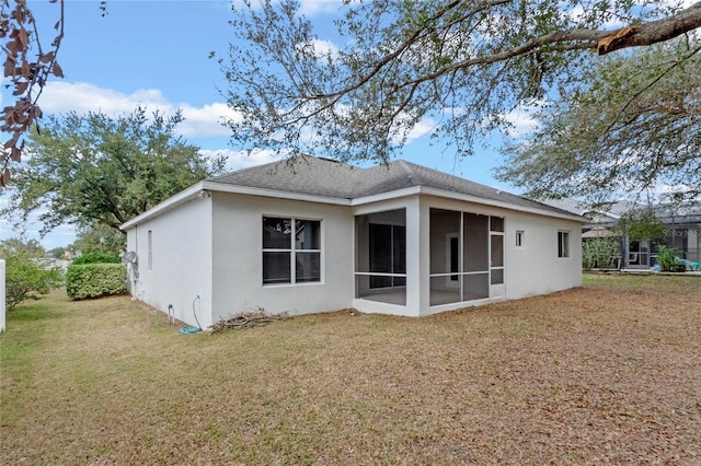 back of property featuring a sunroom and a yard