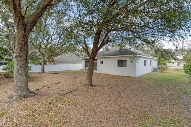 exterior space with cooling unit and a front yard