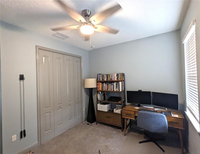 office area featuring ceiling fan, light carpet, and a wealth of natural light