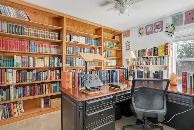 office with ceiling fan and bookshelves