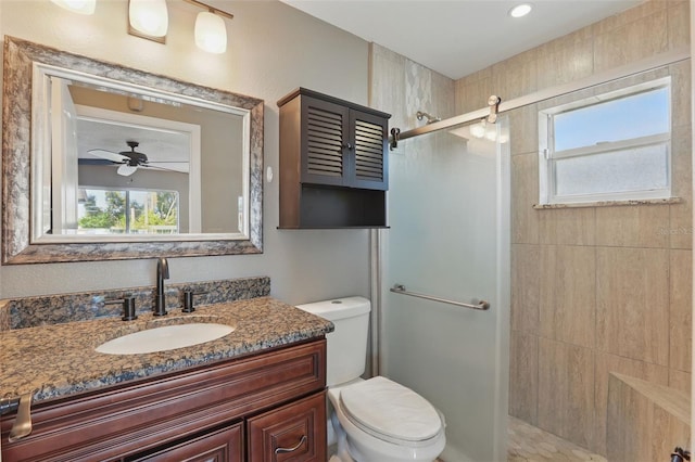 bathroom with toilet, a stall shower, and vanity