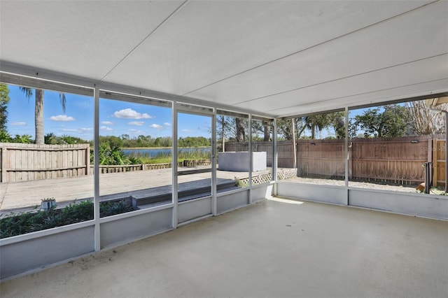 unfurnished sunroom featuring a water view