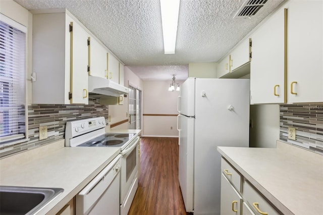 kitchen featuring white appliances, dark wood-type flooring, a textured ceiling, and white cabinets