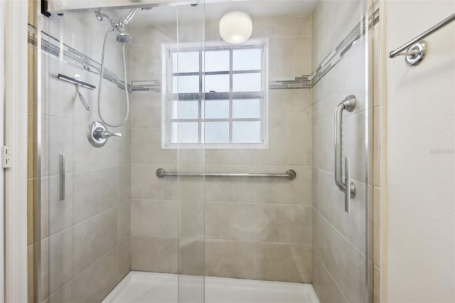 bathroom featuring a shower with shower door