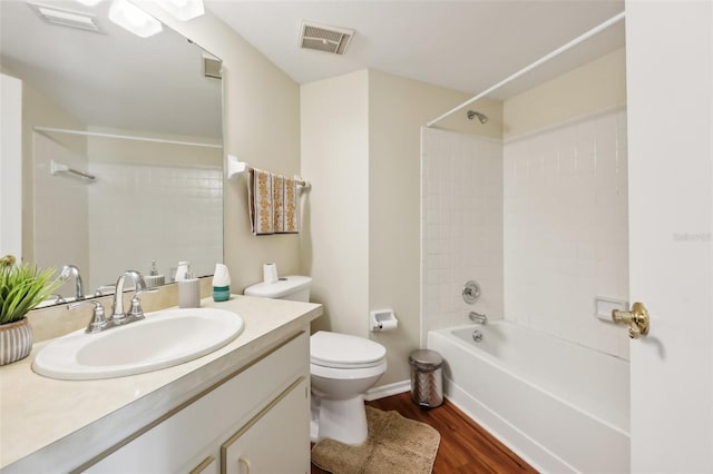 full bathroom featuring vanity, hardwood / wood-style flooring, toilet, and tiled shower / bath