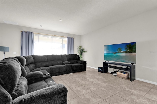 living area with baseboards and light tile patterned floors