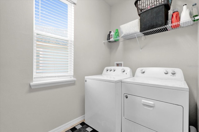 washroom with laundry area, baseboards, and separate washer and dryer