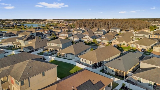 drone / aerial view featuring a water view and a residential view