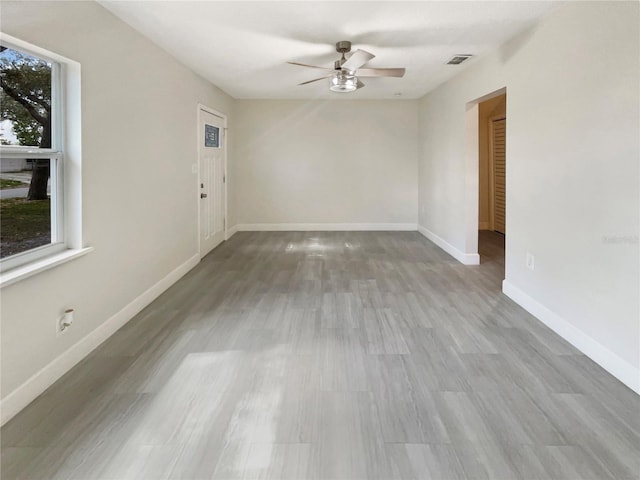 empty room featuring ceiling fan and light hardwood / wood-style flooring