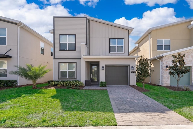 view of front of property with a garage and a front yard