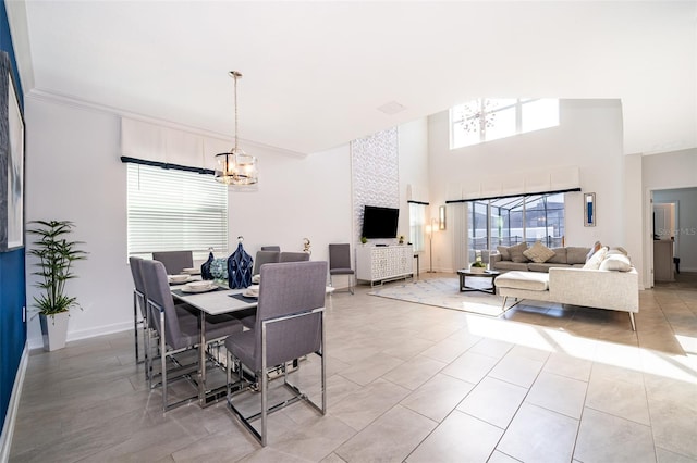 tiled dining area featuring a notable chandelier and a high ceiling