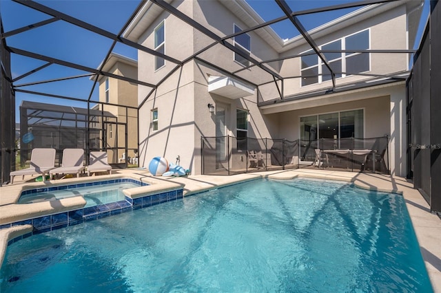 view of pool with an in ground hot tub, a lanai, and a patio area