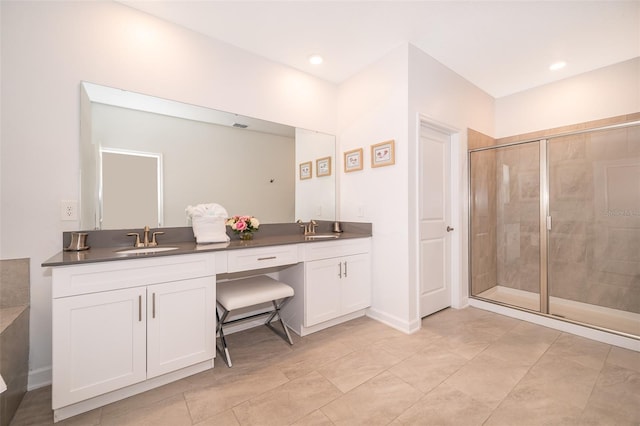 bathroom with vanity and a shower with shower door