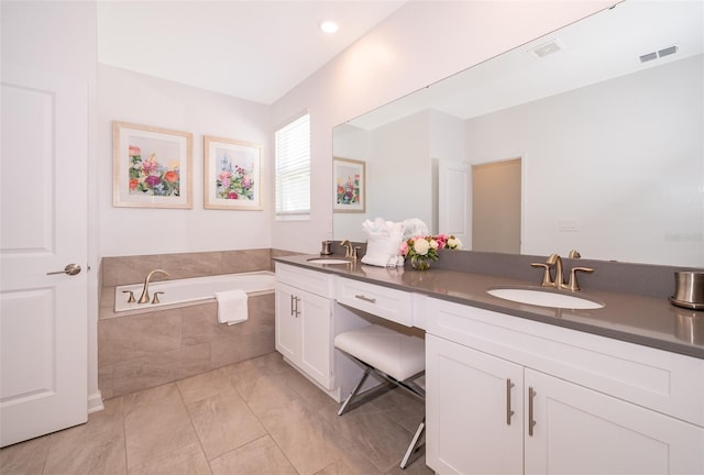 bathroom with vanity and a relaxing tiled tub