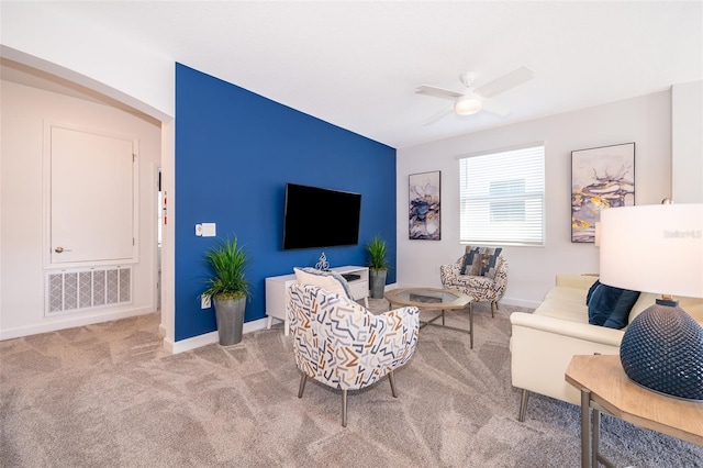 carpeted living room featuring ceiling fan