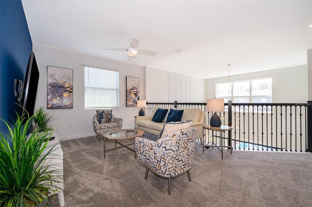 living room featuring a healthy amount of sunlight, carpet floors, and ceiling fan