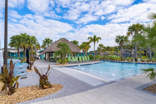 view of pool with a patio and pool water feature