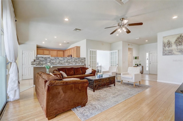 living room with light hardwood / wood-style flooring and ceiling fan