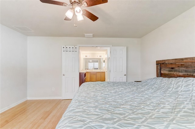 bedroom with ensuite bathroom, ceiling fan, and light wood-type flooring