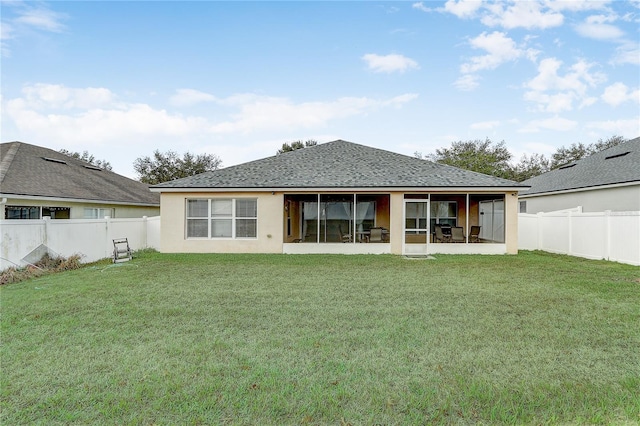 rear view of house with a yard